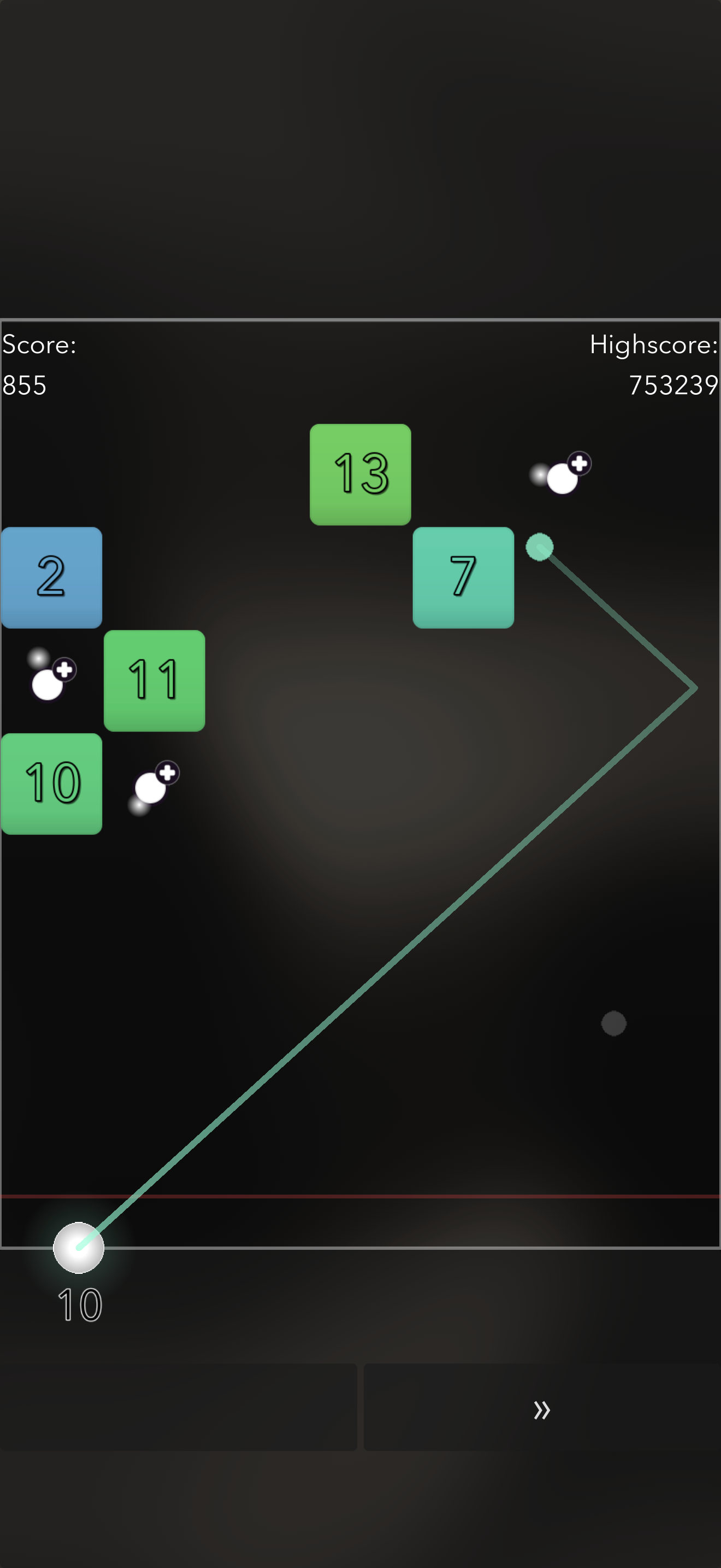 Dragging to aim, with the trajectory preview line bouncing off the walls